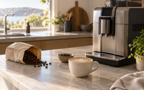 Home coffee machine beside cups and supplies